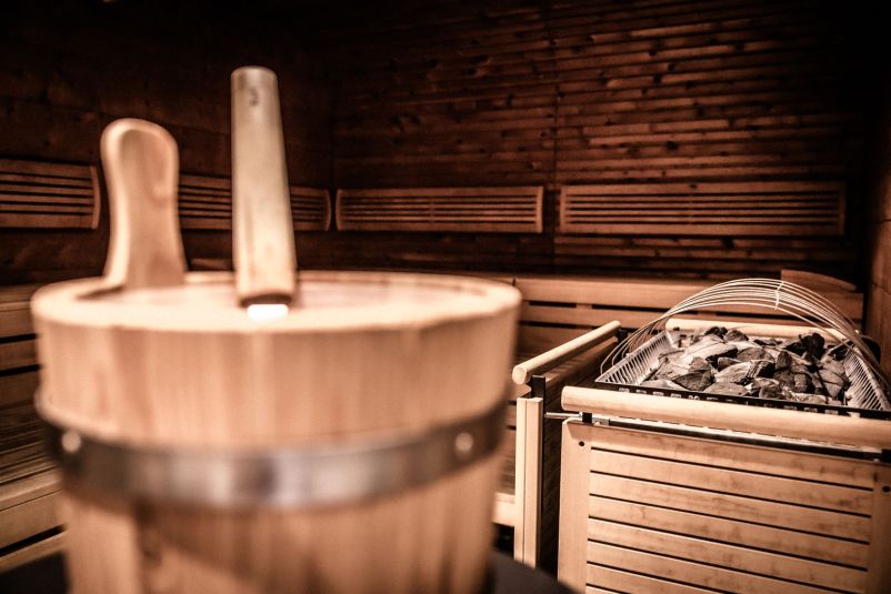 Entspannende Sauna mit Holzeimer und Steinen im klassischen Stil